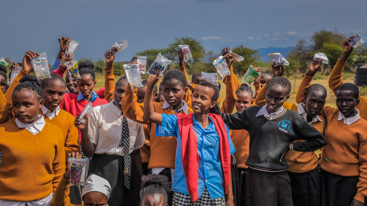 Girls holding menstrual cups